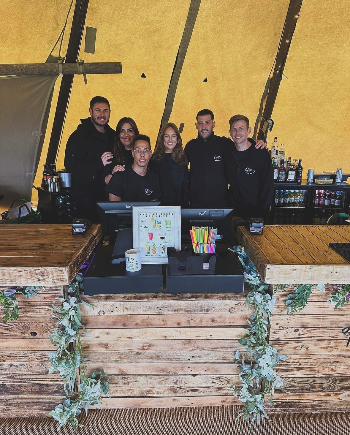 The Distillery Box team tending the bar.